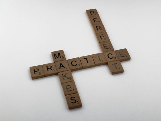 brown wooden cross on white surface