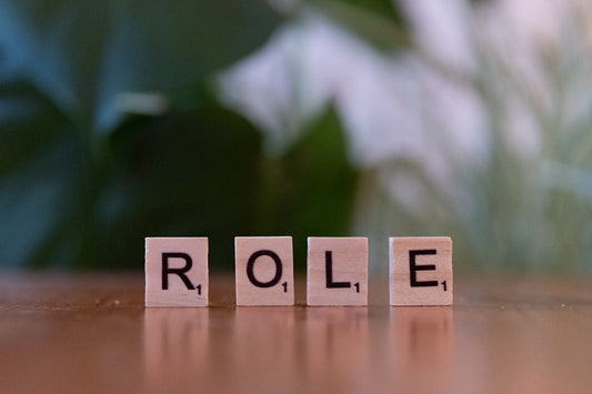 The word role spelled with scrabble blocks on a table