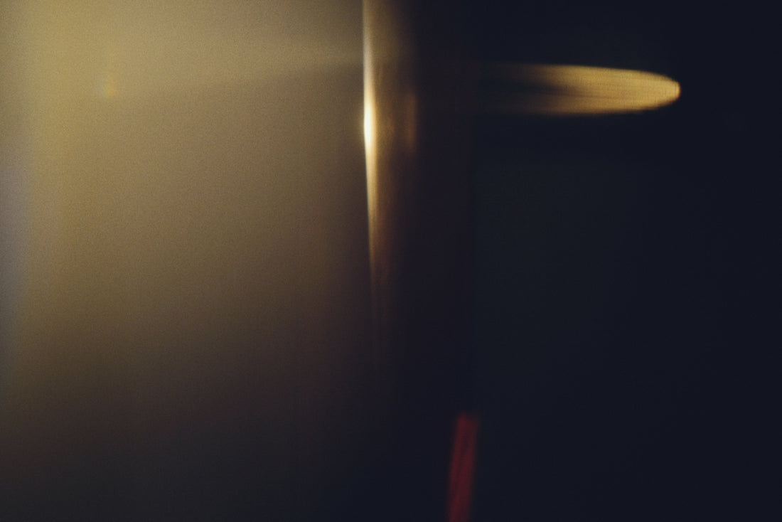 Soft golden light illuminates a dark background