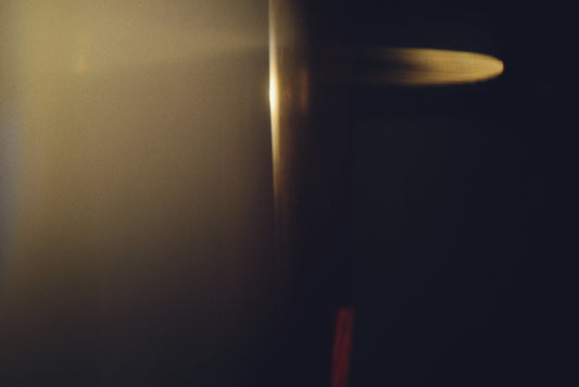 Soft golden light illuminates a dark background